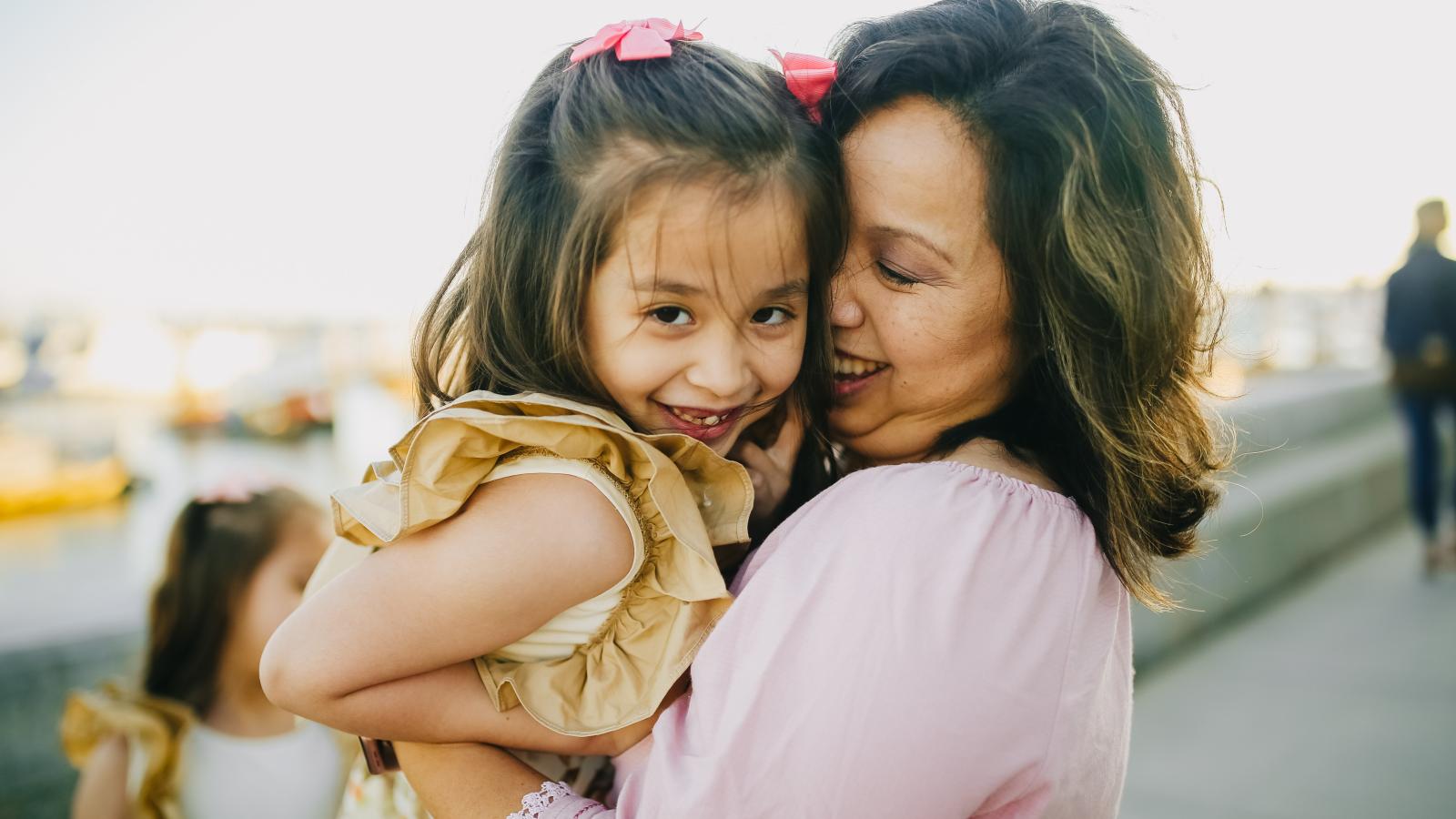woman and daughter smiling and embracing
