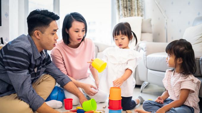 Family playing toy blocks at home 